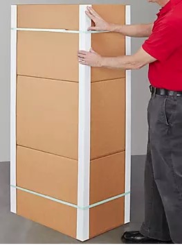 A man standing next to a large Edge Protector (3x3x72) cardboard box.
